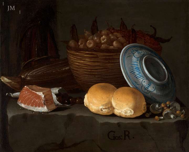 A still life with bread, tuna, olives, cardoons and a basket of figs